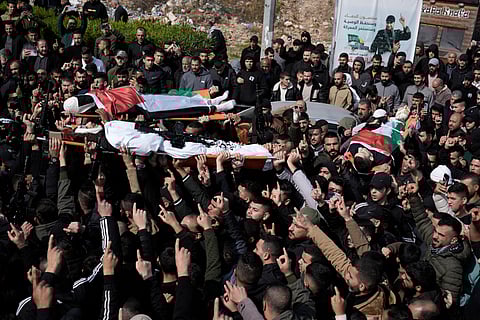 Palestinian mourners carry Mohammed Daraghmeh, 26, foreground, and Muhammad Bayadsa 32, and Osama Zalat 31, during their funeral in the West Bank town of Tubas, Tuesday, Feb. 27, 2024. 
