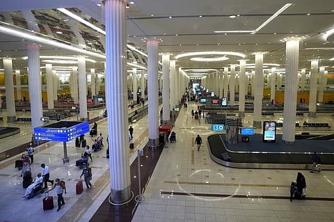 FILE - Passengers leave the baggage handling hall at the Dubai International Airport terminal 3, in Dubai, United Arab Emirates, on Oct. 25, 2022.