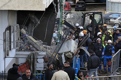 Civil defense and rescue workers remove rubble from a building that was attacked Wednesday night by an Israeli airstrike, Thursday, Feb 15, 2024.