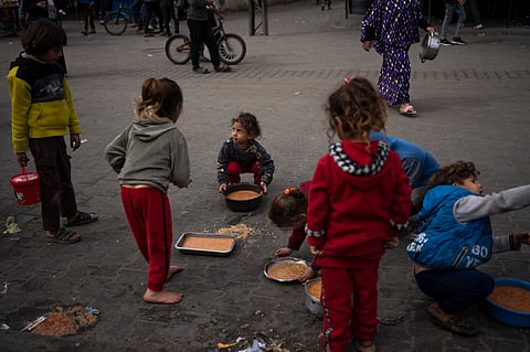 Palestinian kids receive free food in Rafah, Gaza Strip.