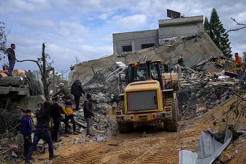 Palestinians search for survivors after an Israeli airstrike on a residential building in Al Zawayda, central Gaza Strip, Sunday, Feb. 18, 2024. 