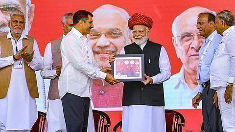 Prime Minister Narendra Modi being felicitated during the golden jubilee celebration of Gujarat Cooperative Milk Marketing Federation (GCMMF), in Ahmedabad, Thursday, Feb. 22, 2024. Gujarat Governor Acharya Devvrat and Union Minister Parshottam Rupala are also seen. 