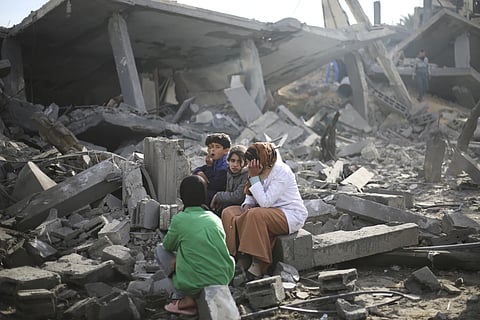 Palestinian family sit by the destruction from the Israeli bombardment of the Gaza Strip in Rafah on Monday, Feb 12, 2024.