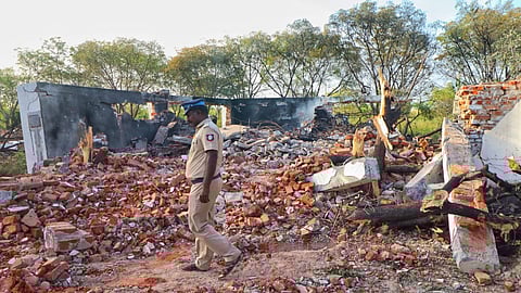 A policeman takes a look at the debris at the blast site.