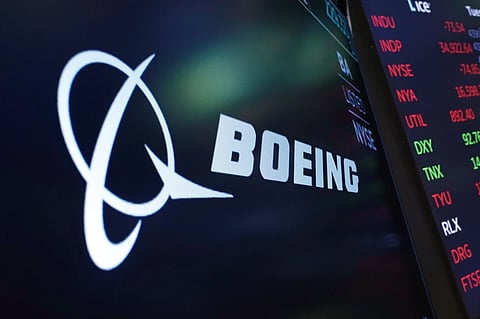 The logo for Boeing appears on a screen above a trading post on the floor of the New York Stock Exchange, July 13, 2021. 
