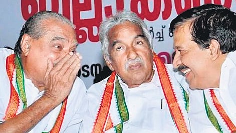 Former Chief Minister of Kerala Oommen Chandy (C) seen with KM Mani and Ramesh Chennithala.