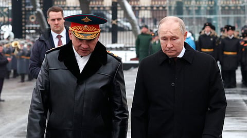Russian President Vladimir Putin, right, and Defence Minister Sergei Shoigu take part in a wreath laying ceremony at the Tomb of the Unknown Soldier in Alexander Garden on Defender of the Fatherland Day, in Moscow, Russia, Friday, Feb. 23, 2024.