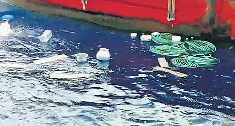 A fishing boat with articles thrown into the sea.