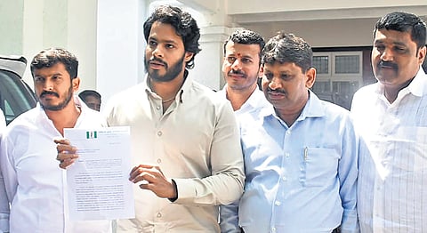 JDS Youth Wing president Nikhil Kumaraswamy holds out a complaint letter against Congress MLA HC Balakrishna in Bengaluru on Friday, Feb 2, 2024.