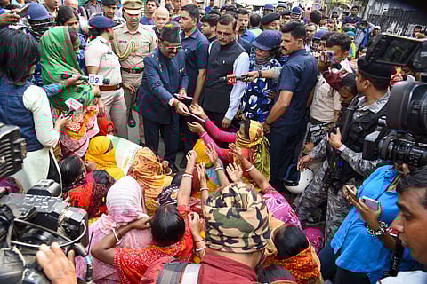 West Bengal Governor CV Ananda Bose with women protestors and others at Sandeshkhali block, in North 24 Parganas district on Feb. 12, 2024. 