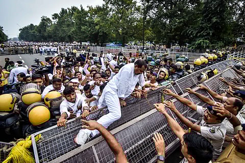 Members of Odisha Pradesh Congress Committee with president Sarat Patnaik and AICC Odisha incharge Ajoy Kumar and senior leaders tussle with police personnel while trying to break the barricades and gherao Lok Seva Bhawan over unemployment and crime against women, at Mahatma Gandhi Marg in Bhubaneswar on Monday.