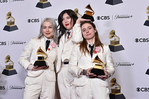 Phoebe Bridgers, from left, Lucy Dacus, and Julien Baker of boygenius pose in the press room with the awards for best rock performance and best rock song for "Not Strong Enough," and best alternative music album for "The Record" during the 66th annual Grammy Awards on Sunday, Feb. 4, 2024, in Los Angeles. 