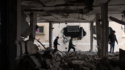Palestinians look at the destruction after an Israeli airstrike in Rafah, Gaza SAtrip, Friday, Feb. 9, 2024.