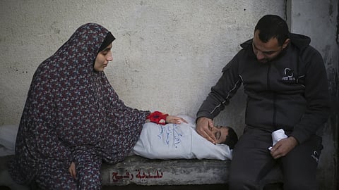 Palestinians mourn a child killed in Israeli bombardment of the Gaza Strip  at a hospital morgue in Rafah, Monday, Feb 12, 2024.