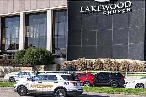 Emergency vehicles line the feeder road outside Lakewood Church during a reported active shooter event.