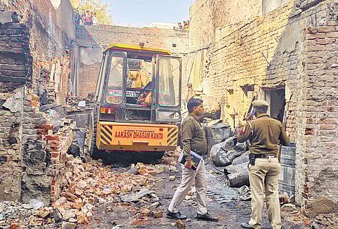 Police at the paint factory where a massive fire broke out on Wednesday at Alipur