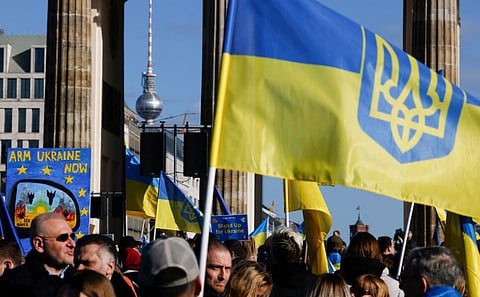 Protestors take part in a rally to support Ukraine, marking the second year of Russia's military invasion on Ukraine, at the Brandenburg Gate in Berlin on February 24, 2024.