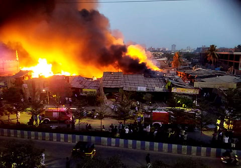 Firefighters at the spot after a fire broke out in a slum, at Bhayandar in Thane district.