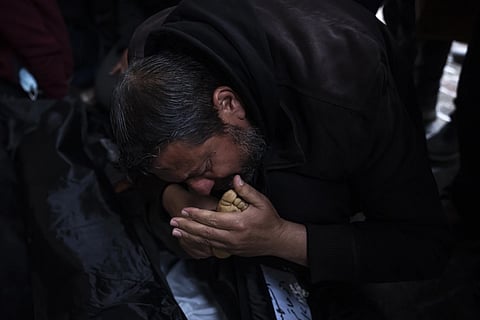 Palestinians mourn their relatives, killed in the Israeli bombardment of the Gaza Strip, outside a morgue in Rafah, Tuesday, Feb 6, 2024.