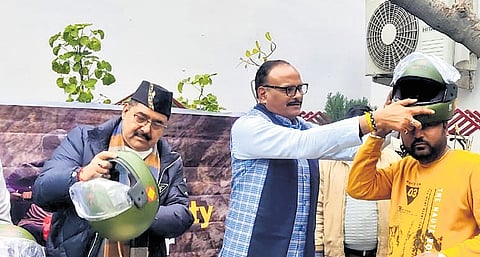 UP Deputy Chief Minister distributing helmets to bikers in Lucknow