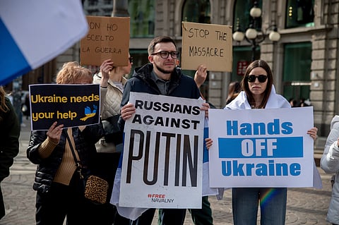 Russian and Ukrainian citizens gather in memory of Alexei Navalny in Milan, Itlay, Saturday Feb. 24, 2024. 