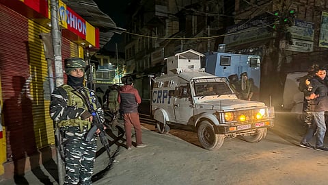 Security personnel stand guard during a cordon and search operation after terrorists shot dead a worker from Punjab while another sustained injuries in the Habba Kadal area, in Srinagar, Wednesday, Feb. 7, 2024.