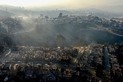 Smoke raises from burnt-out houses after a wildfire reached Villa Independencia neighborhood in Vina del Mar, Chile, Feb. 3, 2024. 