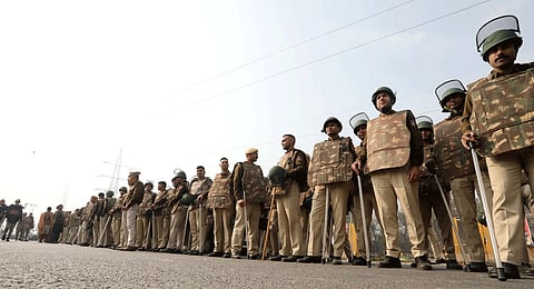 Security personnel stand guard near Singhu Border ahead of the scheduled 'Delhi Chalo' march by the protesting farmers, in New Delhi on Monday.