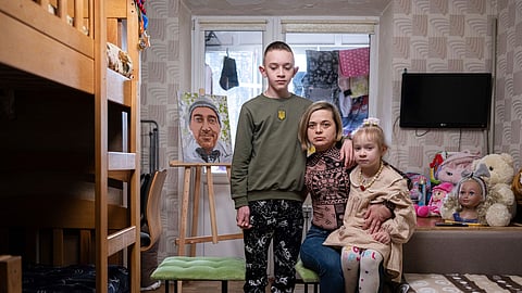 Natalia Sheleshei, 39, with her children Yehor, 12, and Anastasia, 5, wait for the return of Serhii at their apartment in Kyiv, Ukraine on Feb. 12, 2024.