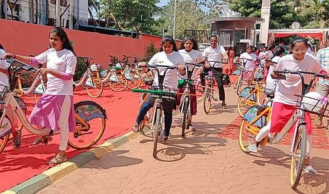 Students riding bicycles during the launch of Public Bicycle Share (PBS) system in Shivamogga on Monday