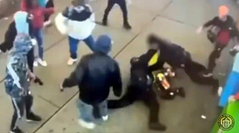 The surveillance footage, recorded Jan. 27 outside a Manhattan homeless shelter, shows several men kicking officers on a sidewalk and trying to pry them off a man police had taken to the ground.
