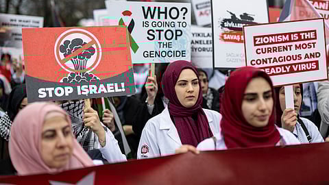 Pro-Palestinian activists and supporters wave flags and carry placards during a National March for Palestine in Istanbul on February 17, 2024.