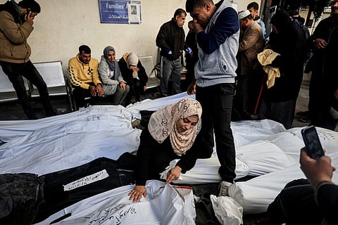 A Palestinian woman mourns over the shrouded body of a relative killed in overnight Israeli bombardment on the southern Gaza Strip at Al-Najjar hospital in Rafah on February 8, 2024, as the conflict between Israel and Hamas enters its fifth month. 