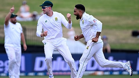 South Africa bowler Dane Piedt, right, celebrates after taking the wicket of New Zealand's Kane Williamson on the second day of their cricket test in Hamilton, New Zealand on Wednesday, Feb. 14, 2024.