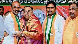 BJP MP Bandi Sanjay greets party’s state in-charge Tarun Chugh at a LS Pravas Yojana meeting in Karimnagar.
