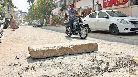 A biker dodges a slab of stone placed in the middle of Dasarivari street in Suryaraopet , Vijayawada.