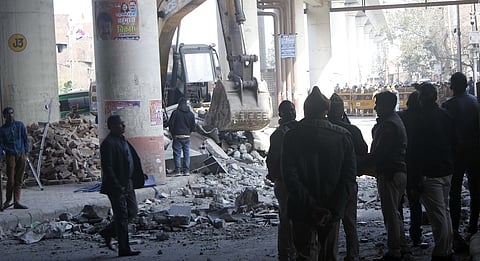 Officials stand near debris after a portion of the Gokulpuri Metro Station on the Pink Line collapsed, in New Delhi, Thursday, Feb. 8, 2024.