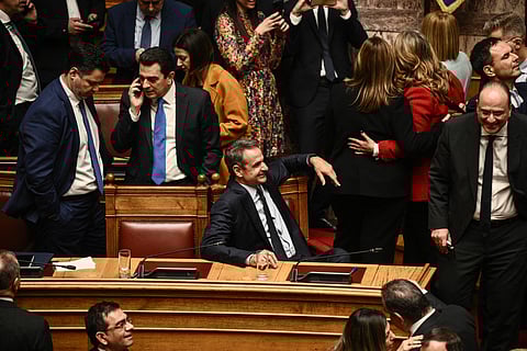 Prime Minister Kyriakos Mitsotakis (C) attends the parliamentary vote on same-sex marriage in Athens, February 15, 2024. The legalization of same-sex marriage in Greece, adopted by MPs on February 15 evening, is "a turning point for human rights", according to conservative Prime Minister Kyriakos Mitsotakis, who championed the reform.