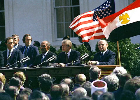 Former U.S. President Jimmy Carter, former Egyptian President Anwar Sadat and former Israeli President Menachem Begin attend the formal ceremony for the Camp David Accords in Washington, D.C., March 26, 1969, designed to bring peace to the Middle East. 