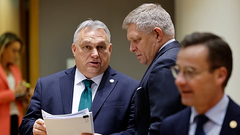 Slovakia's Prime Minister Robert Fico, right, talks to Hungary's Prime Minister Viktor Orban during a round table meeting at an EU summit in Brussels, Thursday, Feb. 1, 2024.