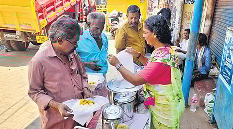 Jalaja distributing food near Palkulangara Devi temple in Kollam 