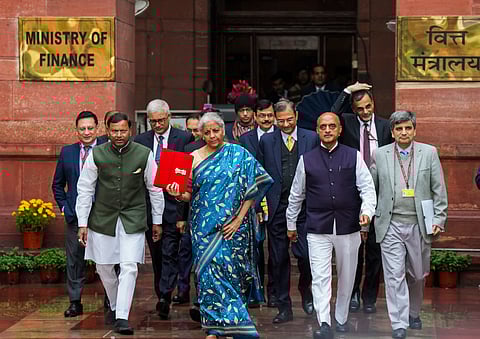 People watch Union Finance Minister Nirmala Sitharaman presenting the Interim Budget 2024 in Parliament, at a television showroom.