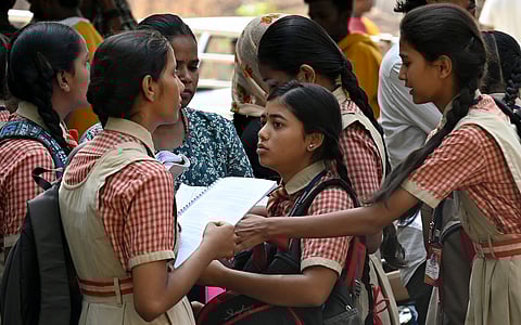 Students arrive to give their SSLC examination at a State government school in Bengaluru
