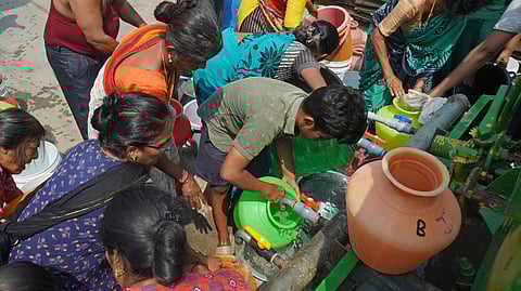 People collect free water from water tankers in Bengaluru. 