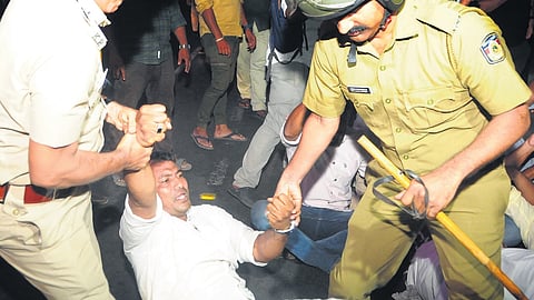 Police remove Youth League workers protesting in front of the KSRTC bus stand in
Kozhikode following the death of a farmer in gaur attack at Kakkayam