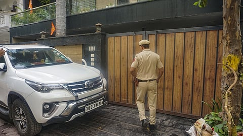 Security personnel stand guard outside AAP leader Deepak Singla's residence during a raid by Enforcement Directorate  