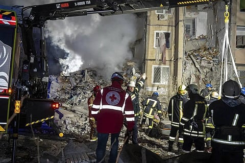 In this photo provided by Ukrainian Emergency Service, workers clear the rubble on the destroyed building in Odesa, March 2, 2024.