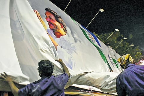 Workers removing banners of political parties in Vijayawada after the Model Code  of Conduct came into force on Saturday 