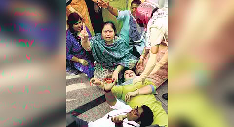 AAP supporters during a protest over the arrest of Kejriwal at ITO in central Delhi on Sunday