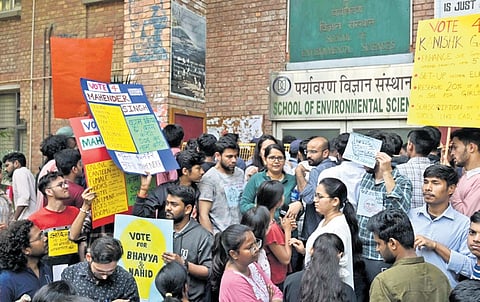 Students shout slogans amid polling for the JNUSU elections.